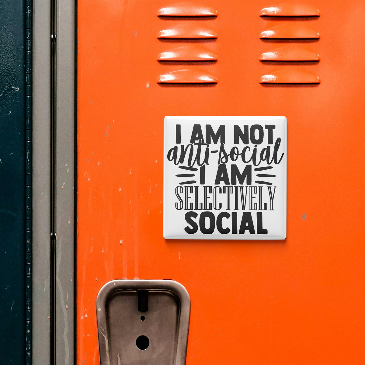 a sticker with the text "I am not anti-social I am selectively social" on an orange surface, which appears to be a locker or a similar storage unit.