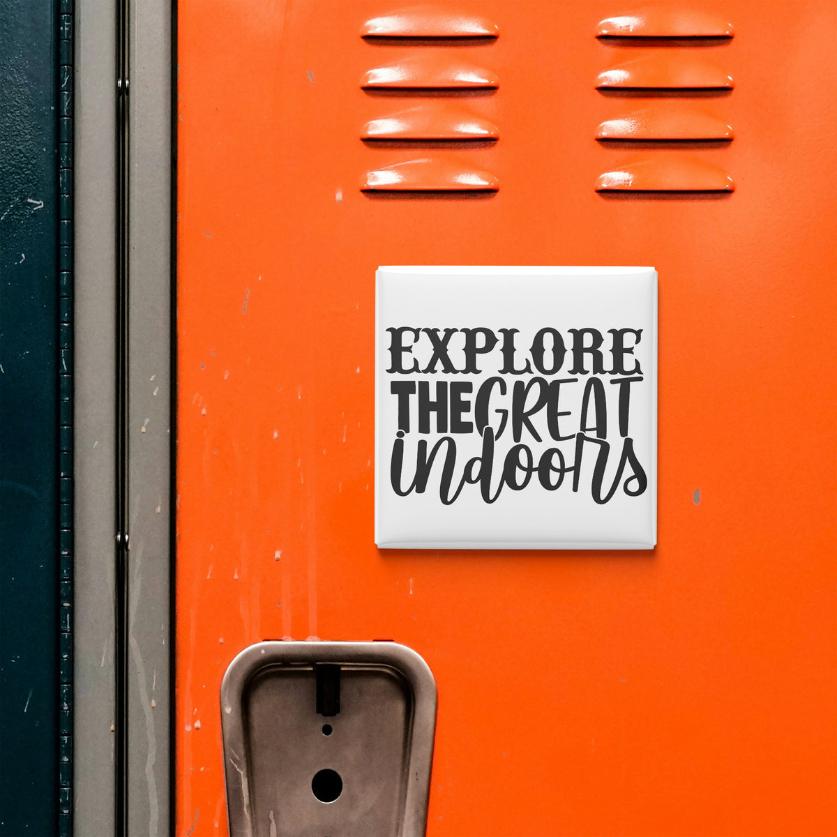 a bright orange surface with a sign that says "EXPLORE THE GREAT Indoors" in bold black letters.