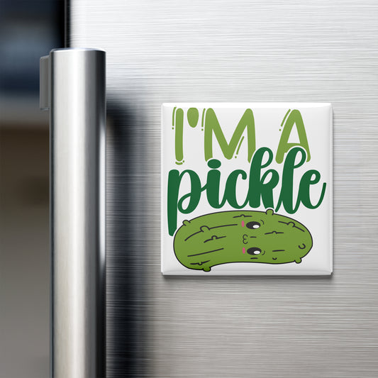 A white refrigerator door with a humorous magnet that says "I'm a pickle" and features a cartoon image of a pickle.