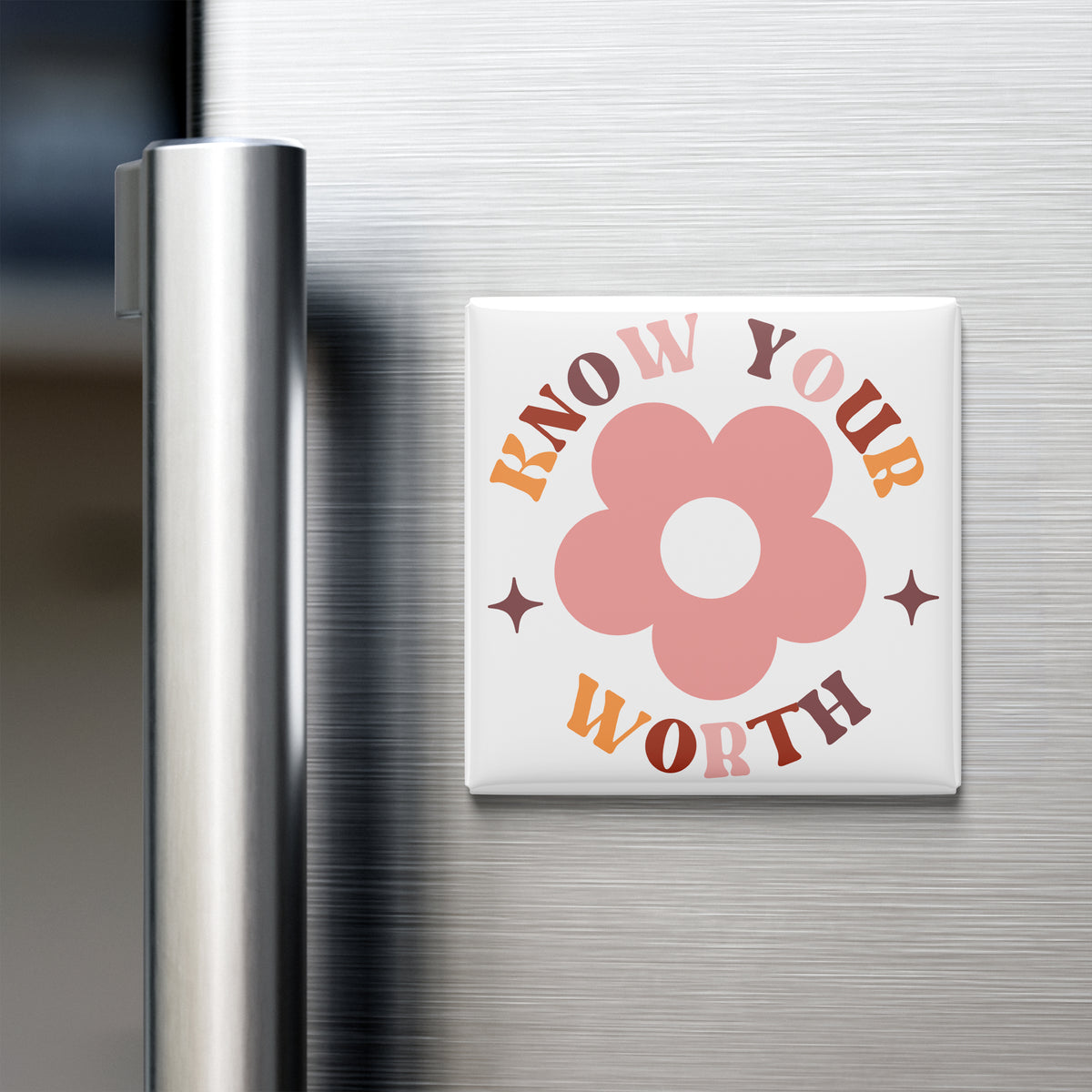 A white square magnet with a pink flower design and the text "KNOW YOUR WORTH" on it, placed on the surface of a stainless steel refrigerator.