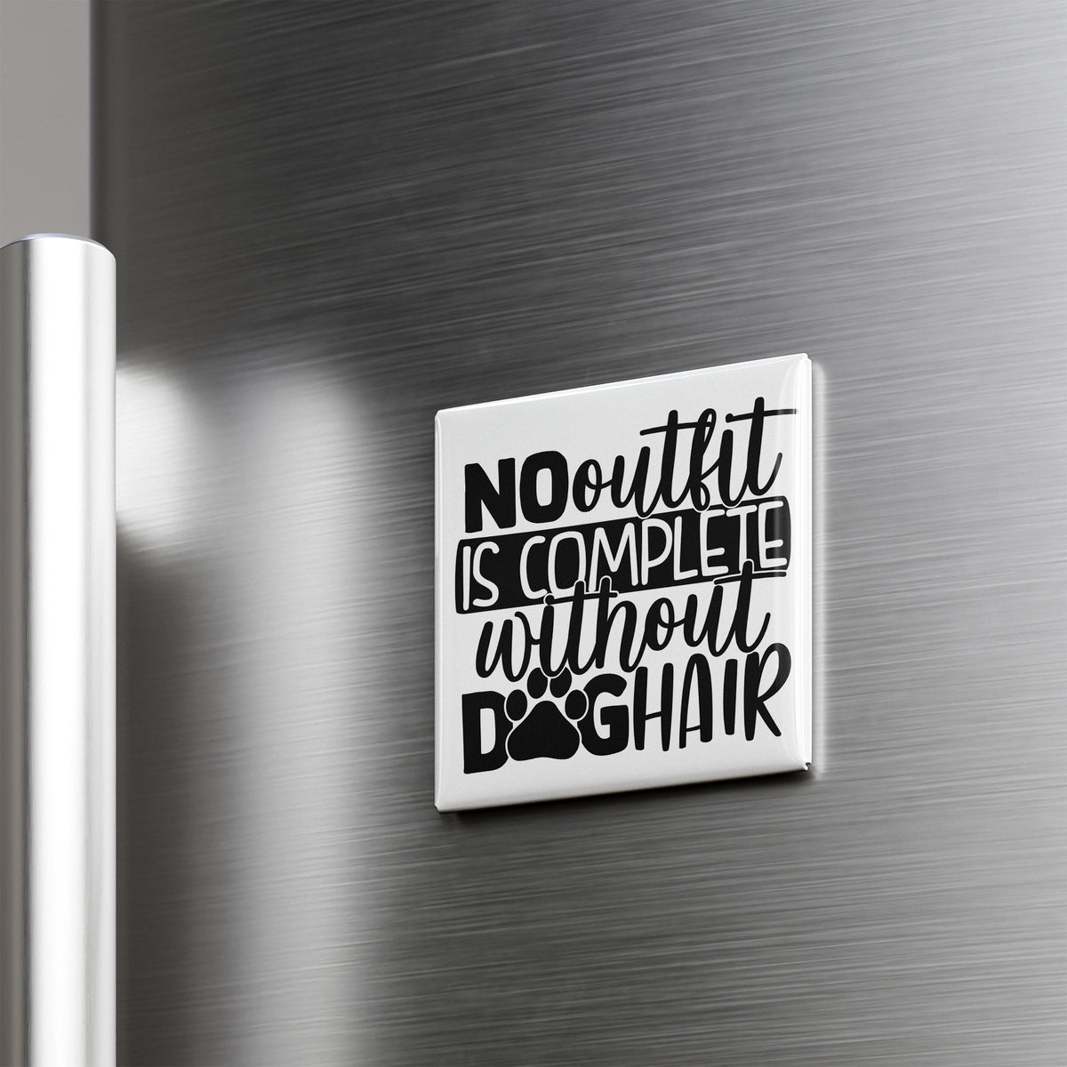 a white square magnet with the text "NO outfit is complete without dog hair" printed on it.