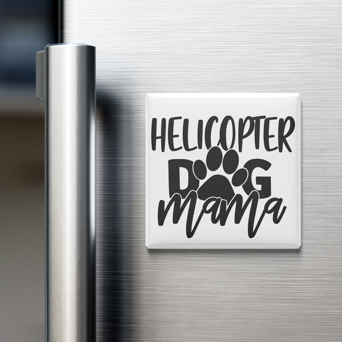 A refrigerator door with a magnet that says "HELICOPTER DOG MAMA" in a stylized font.