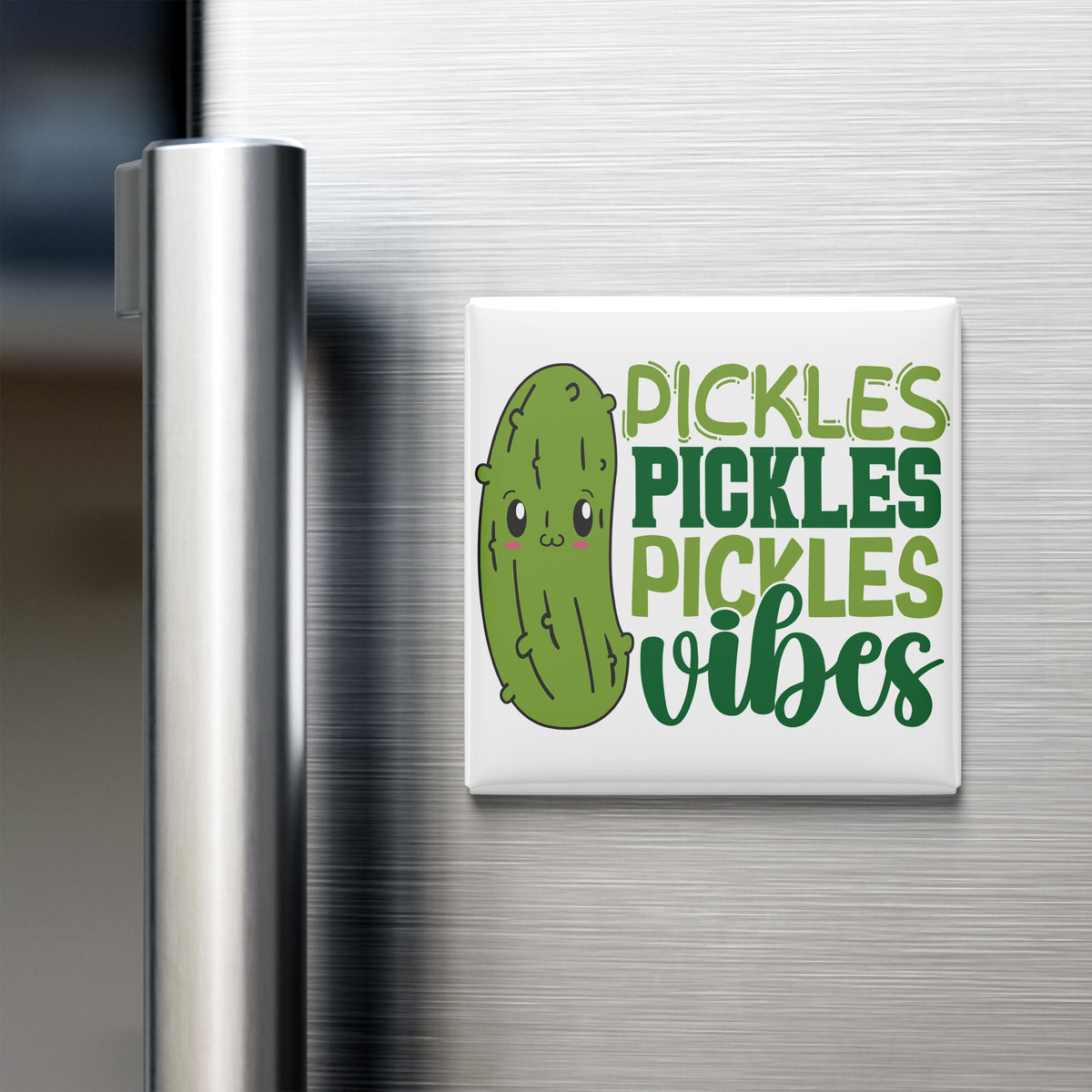 A refrigerator door with a magnet that says "Pickles, Pickles, Vibes" featuring a cartoon pickle.