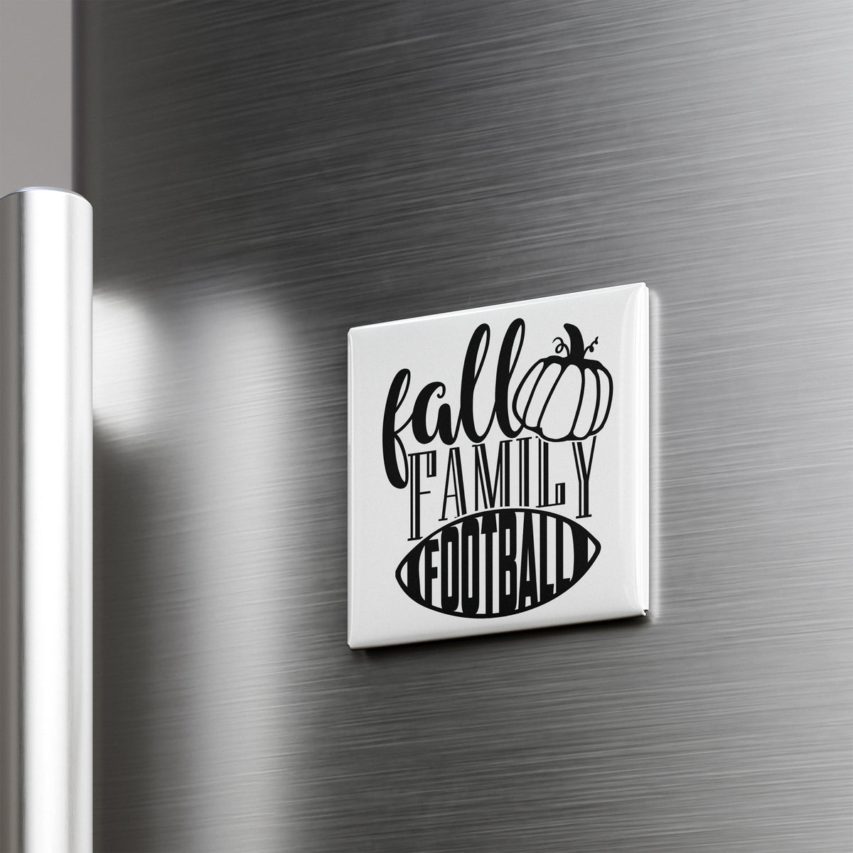 A refrigerator door with a white magnet that says "fall family football" in a stylized font.