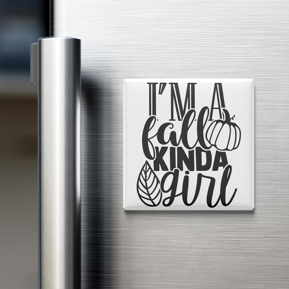 A refrigerator door with a magnet that says "I'm a fall kinda girl" in a stylized font.
