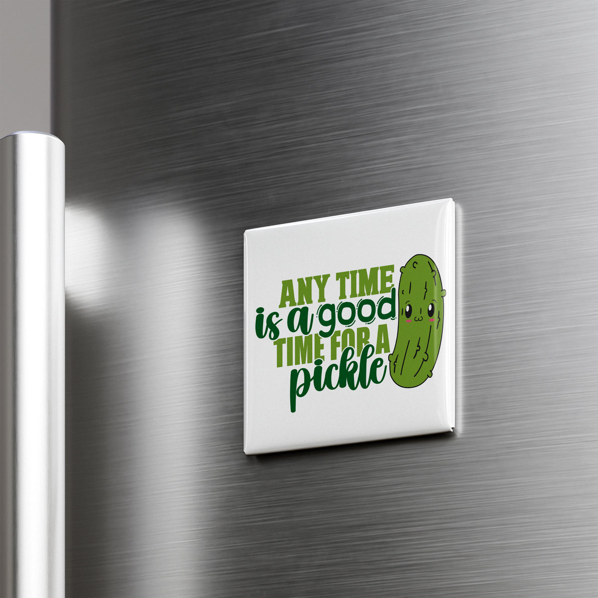 A white refrigerator magnet with a green pickle and the text "Any time is a good time for a pickle" printed on it.