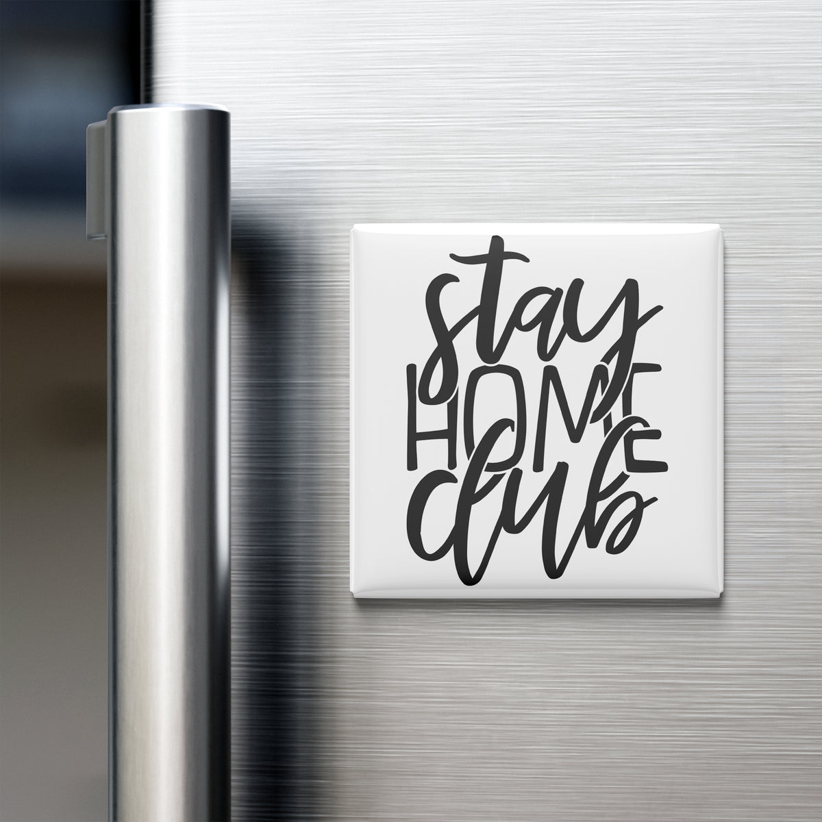 A white magnet with the text "Stay Home Club" on it is attached to the side of a stainless steel refrigerator.