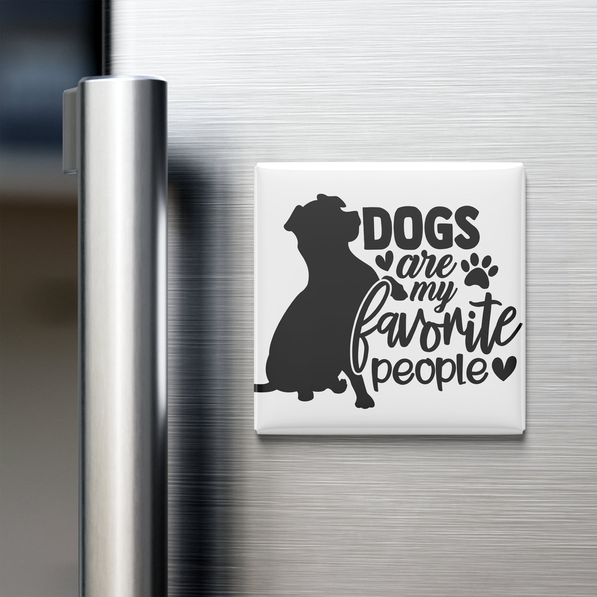 A refrigerator magnet with the text "Dogs are my favorite people" and a silhouette of a dog.