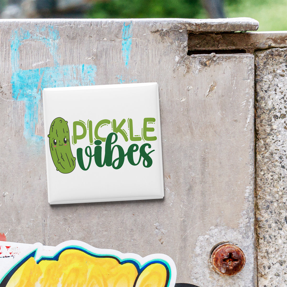 a sticker with the text "Pickle Vibes" on a concrete surface.