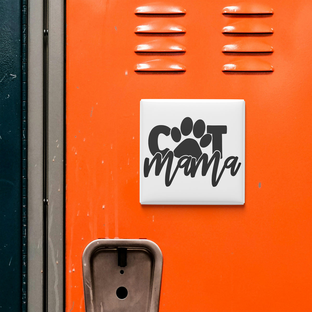 a close-up of an orange surface with a sign that says "Cat Mama" in black text.