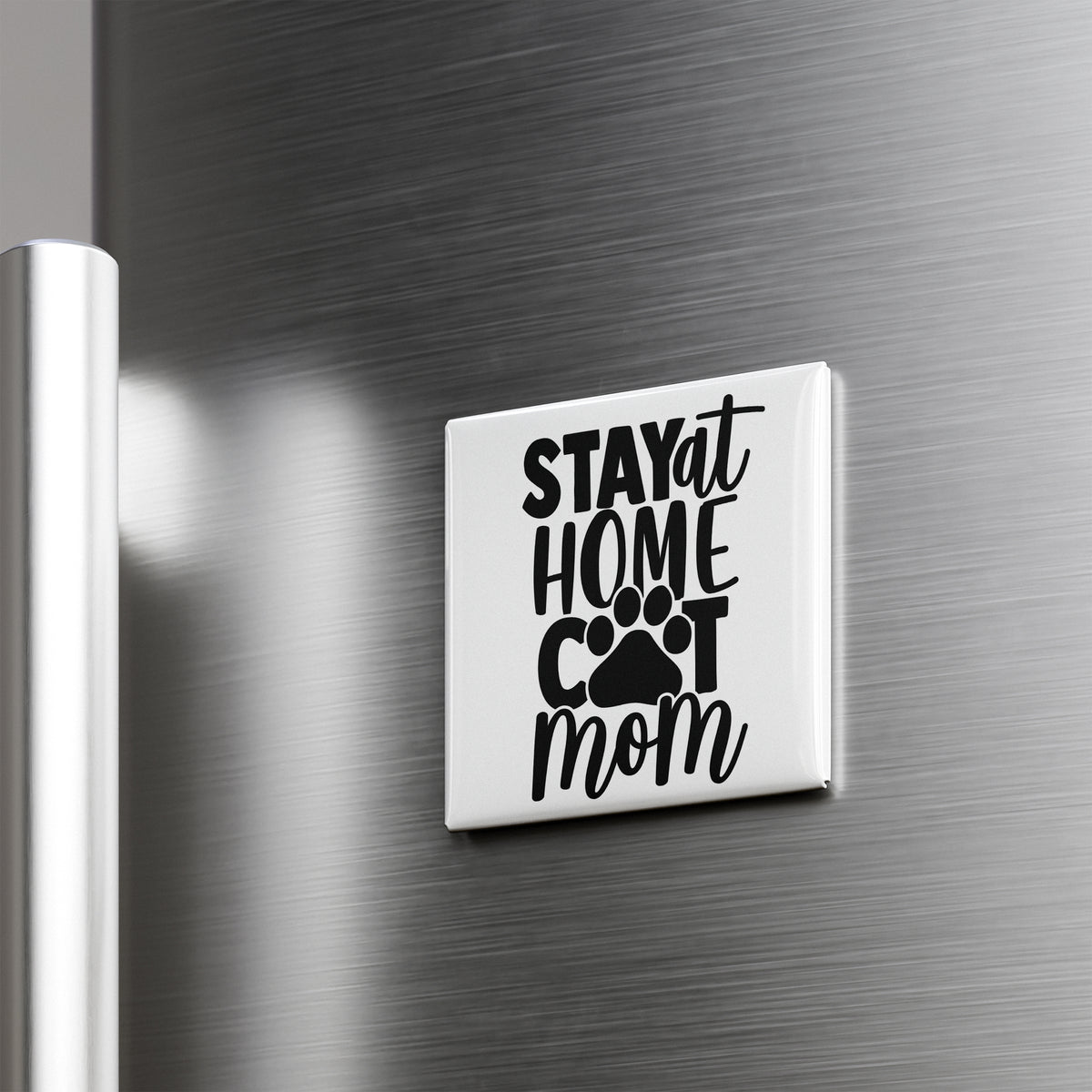 A white refrigerator door with a black and white sticker that says "STAY AT HOME COT MOM".
