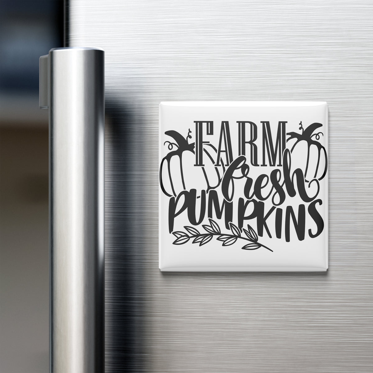 A refrigerator door with a magnet that says "FARM FRESH PUMPKINS" in a stylized font.