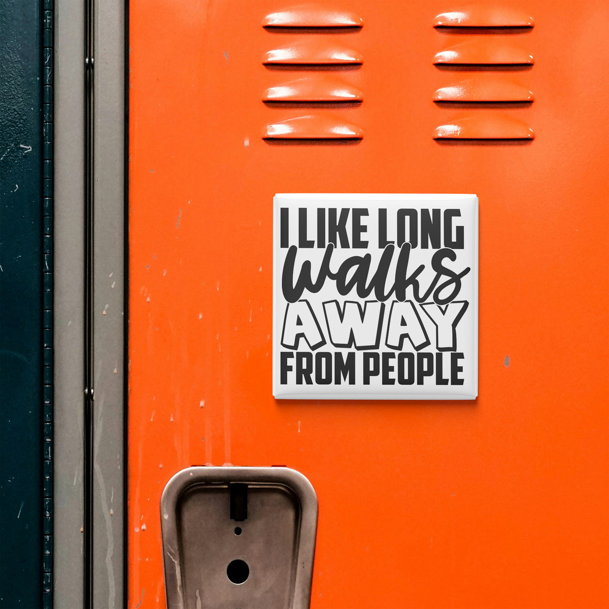 a sticker with the text "I LIKE LONG WALKS AWAY FROM PEOPLE" on an orange surface, which appears to be a locker or a similar storage unit.