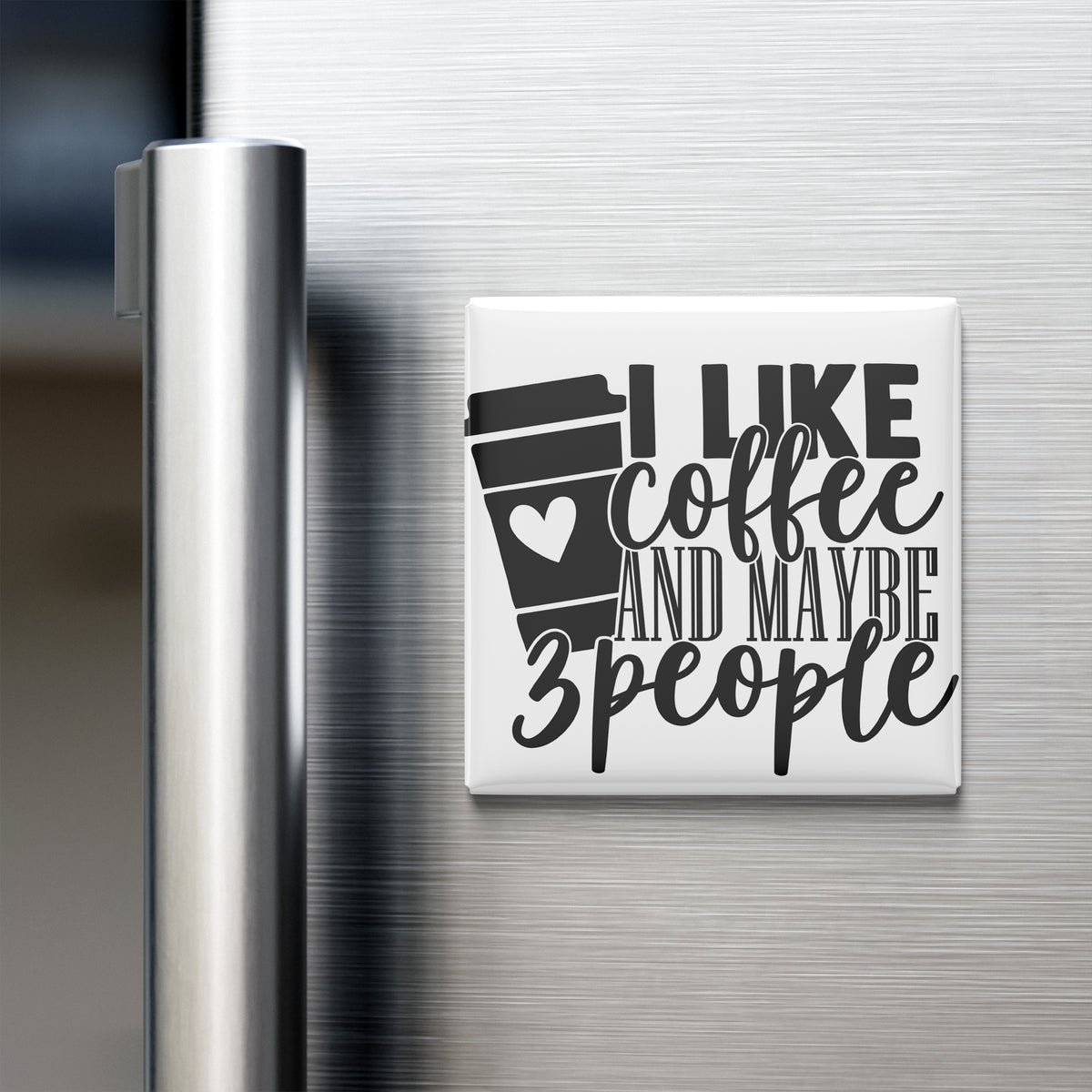 A white refrigerator magnet with the text "I LIKE coffee AND maybe 3 people" printed on it.