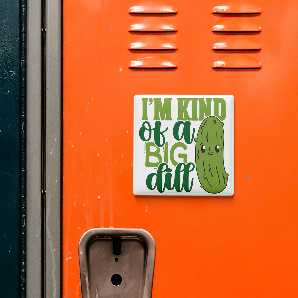 a sticker with a cartoon pickle and the text "I'm kind of a big dill" on an orange surface.