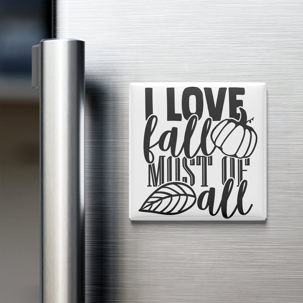 A white refrigerator magnet with the text "I LOVE fall MOST of all" printed on it.