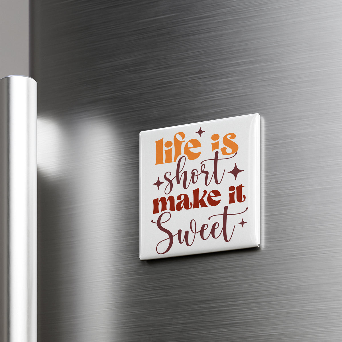 A white refrigerator magnet with the text "Life is short, make it sweet" in orange and brown colors.