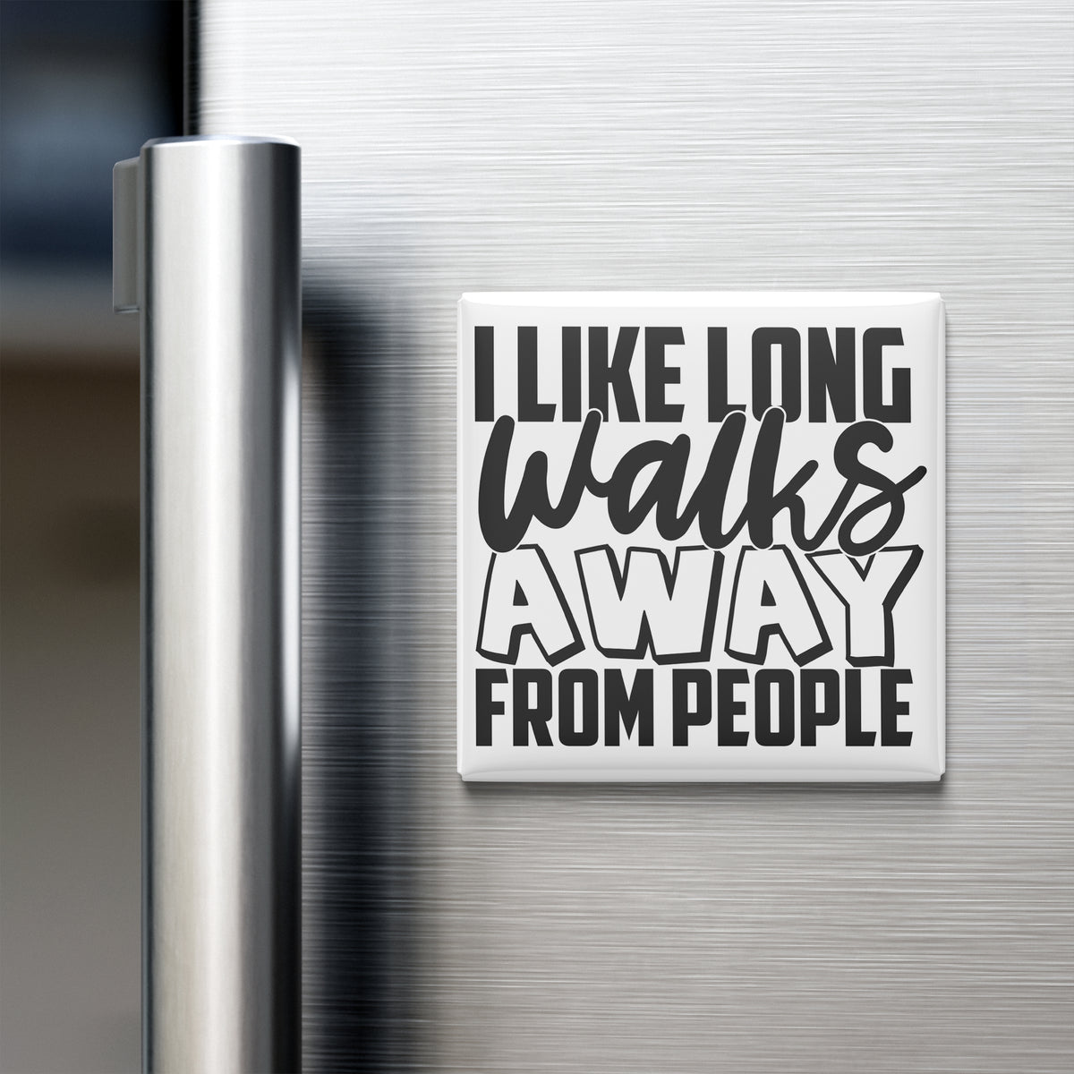 a refrigerator with a magnet that says "I LIKE LONG WALKS AWAY FROM PEOPLE".