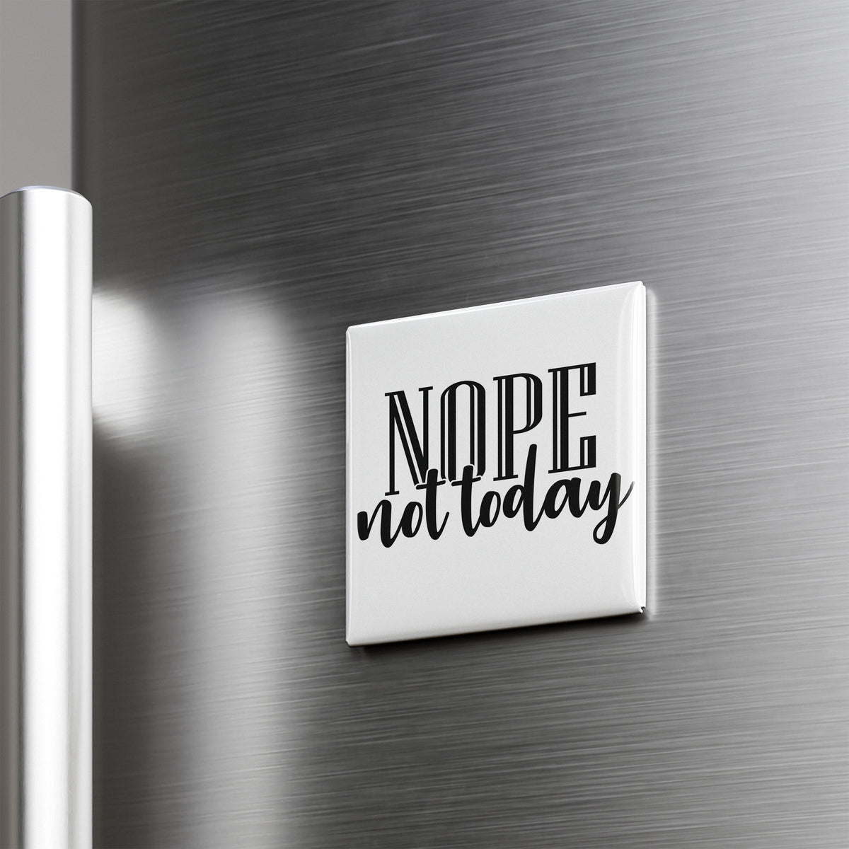 A white square magnet with the text "NOPE not today" on it is attached to a metallic surface.