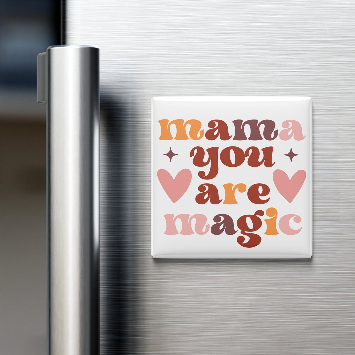 A white refrigerator door with a colorful magnet that says "mama you are magic" in a retro style.