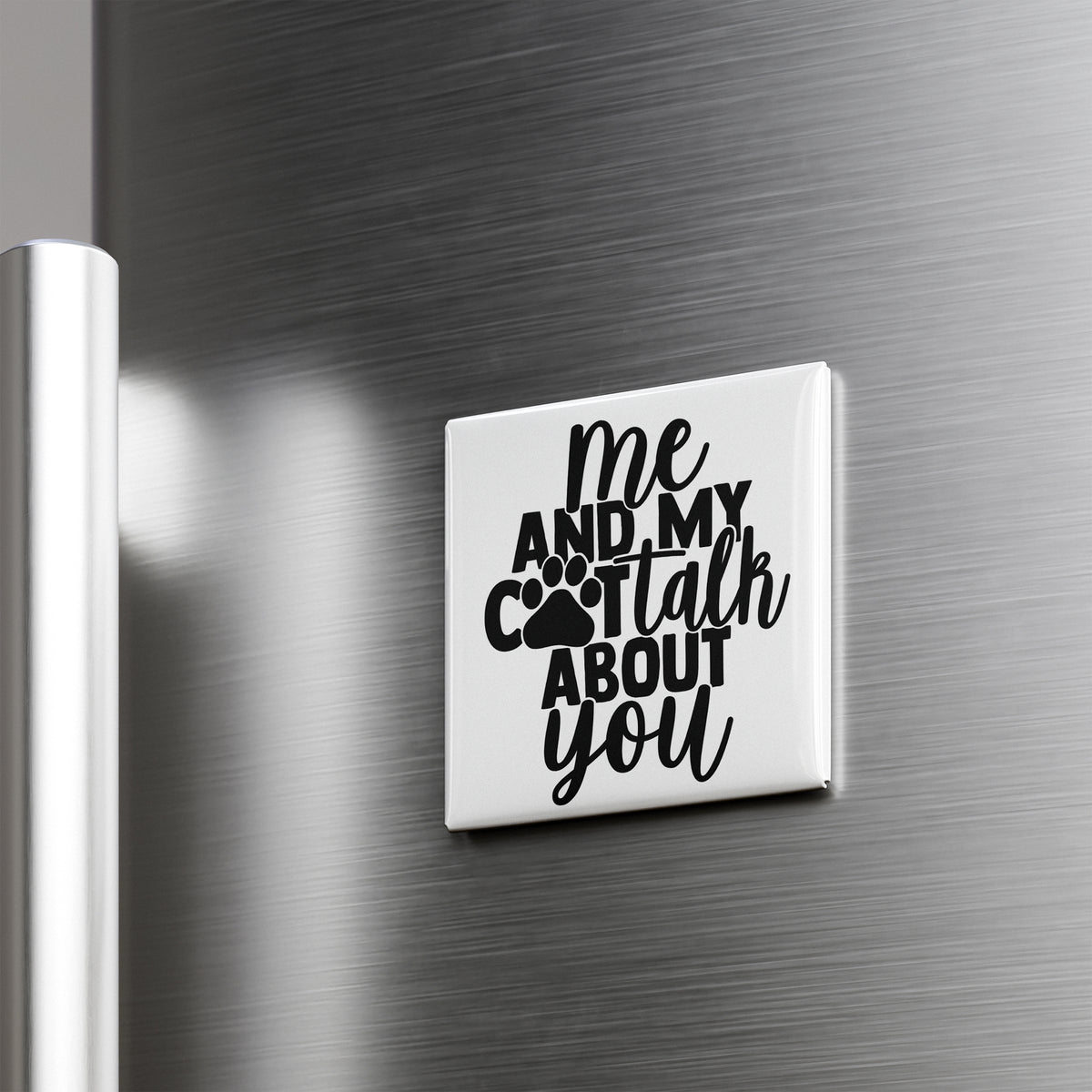 A white refrigerator magnet with the text "me and my cat talk about you" printed on it.
