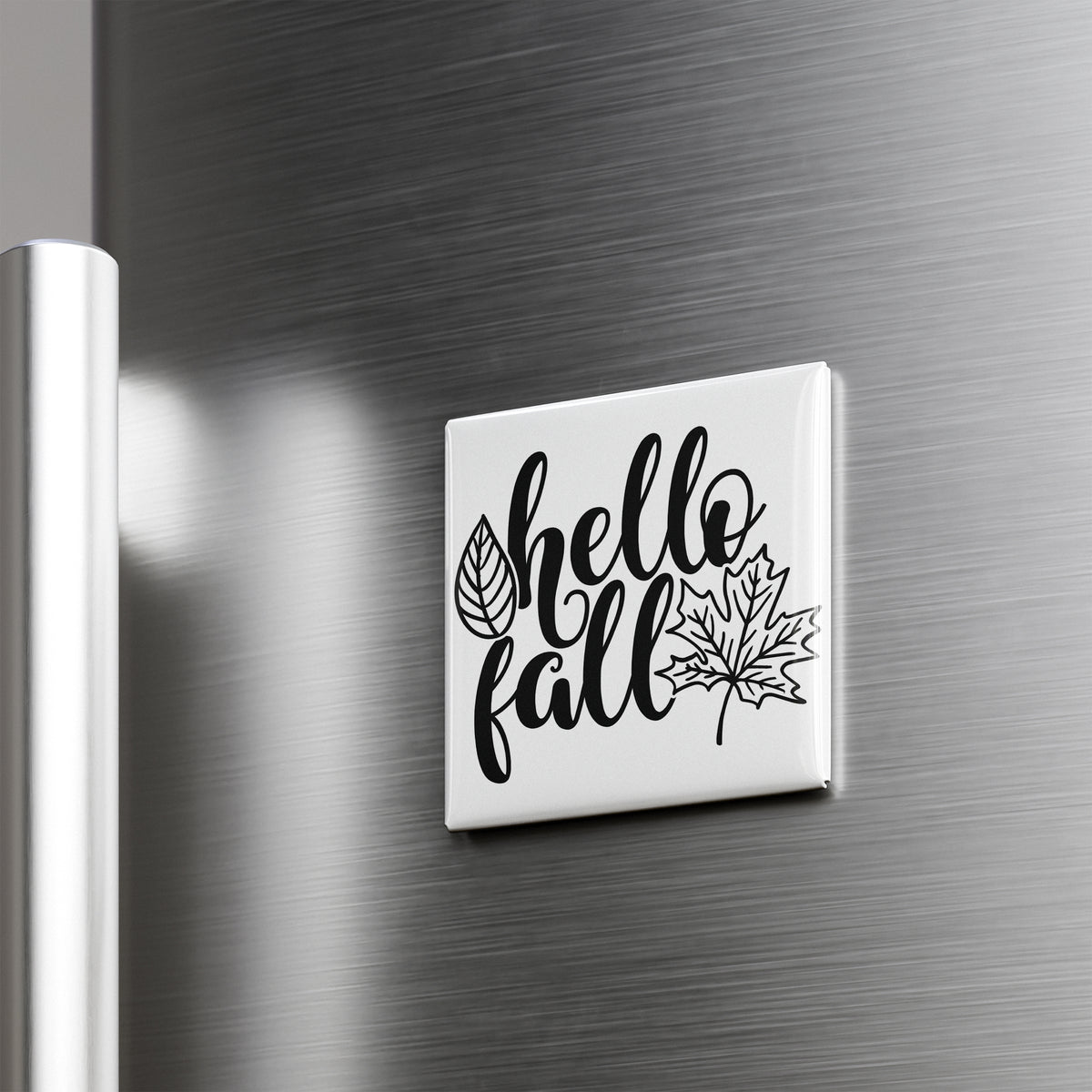 A white refrigerator magnet with the text "Hello fall" and a leaf graphic.