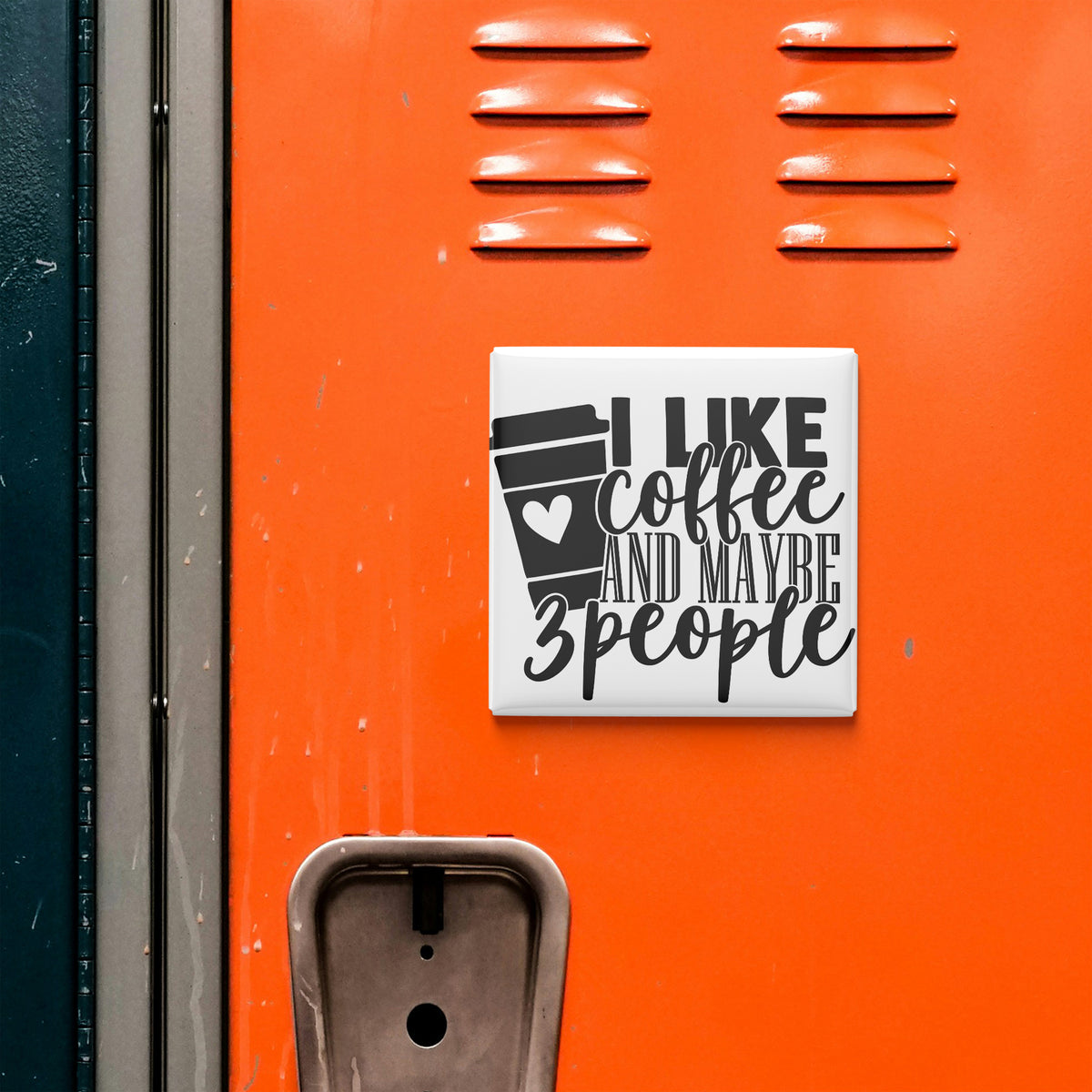 a sticker with the text "I LIKE coffee AND maybe 3 people" on an orange surface, which appears to be a locker or a metal door.