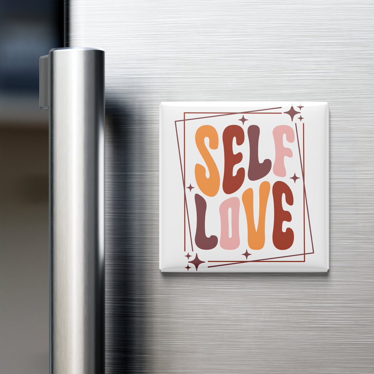A white refrigerator door with a colorful magnet that says "SELF LOVE" in a stylized font.
