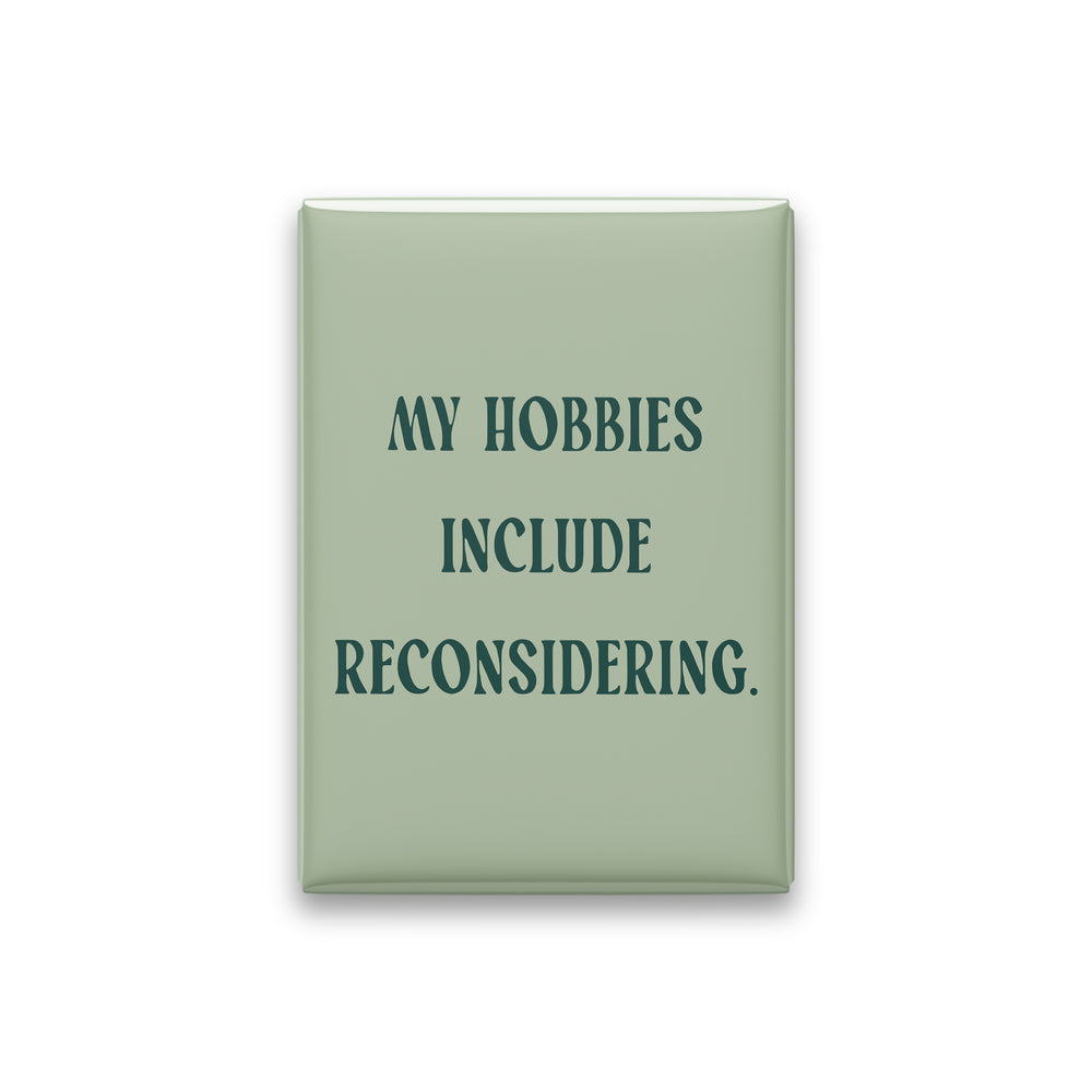 “My hobbies include reconsidering.” sage quote magnet on white