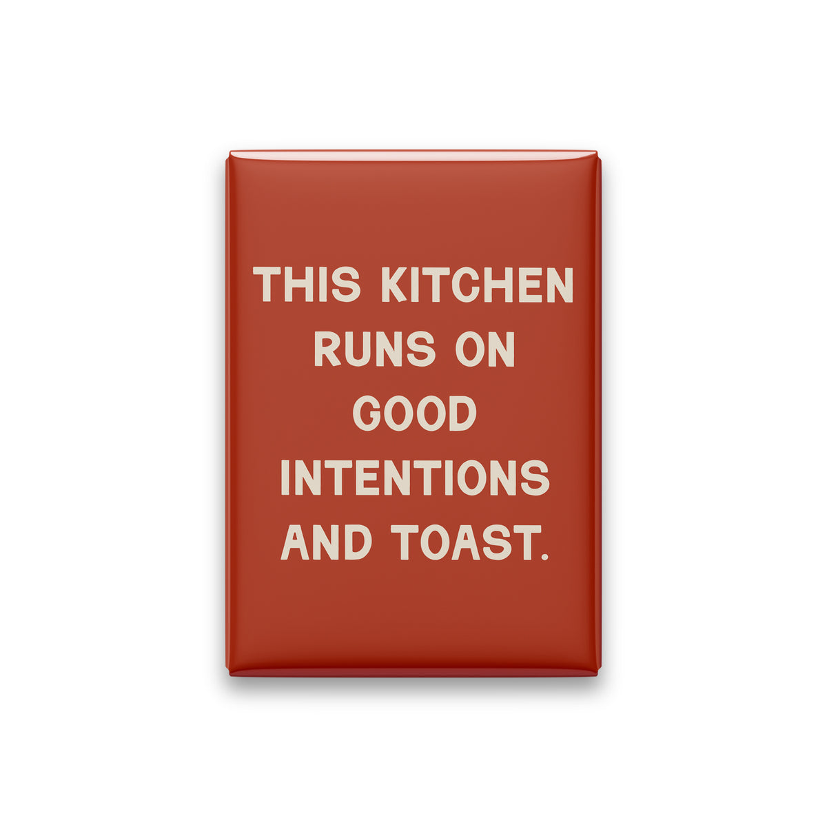 “This kitchen runs on good intentions and toast.” terracotta quote magnet on white