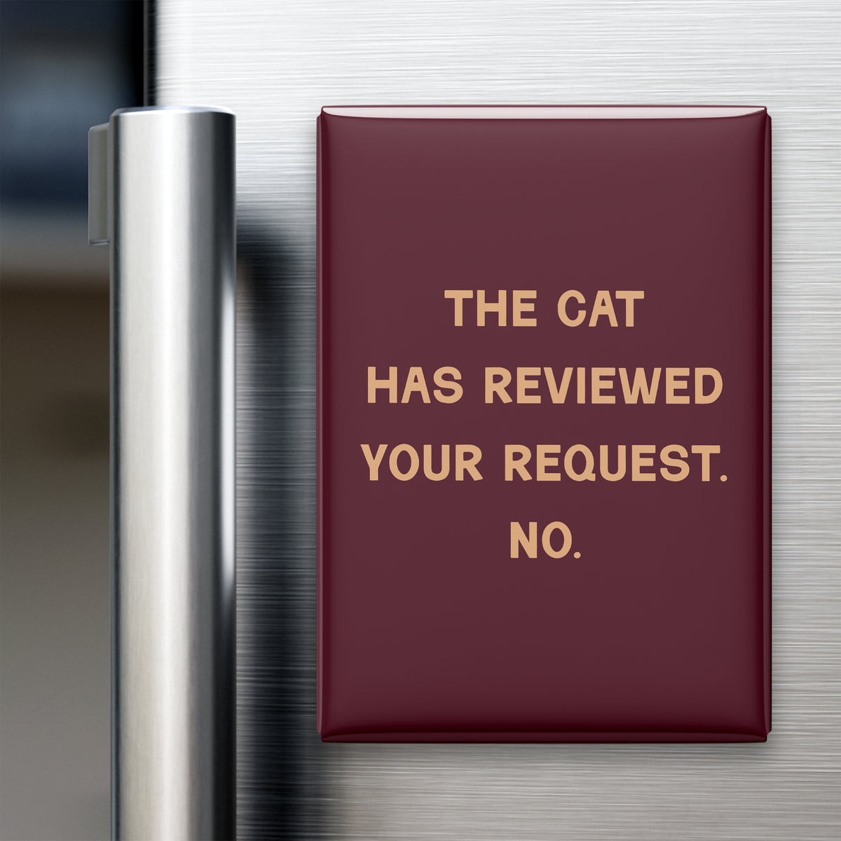 “The cat has reviewed your request. No.” quote magnet displayed on a refrigerator