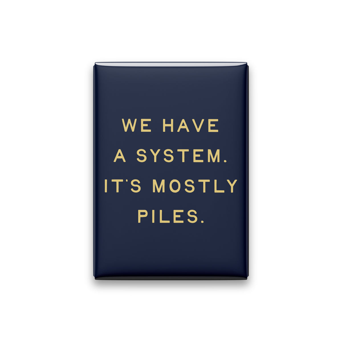“We have a system. It's mostly piles.” midnight quote magnet on white