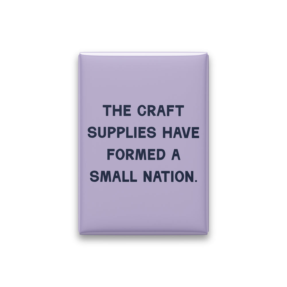 “The craft supplies have formed a small nation.” lilac quote magnet on white