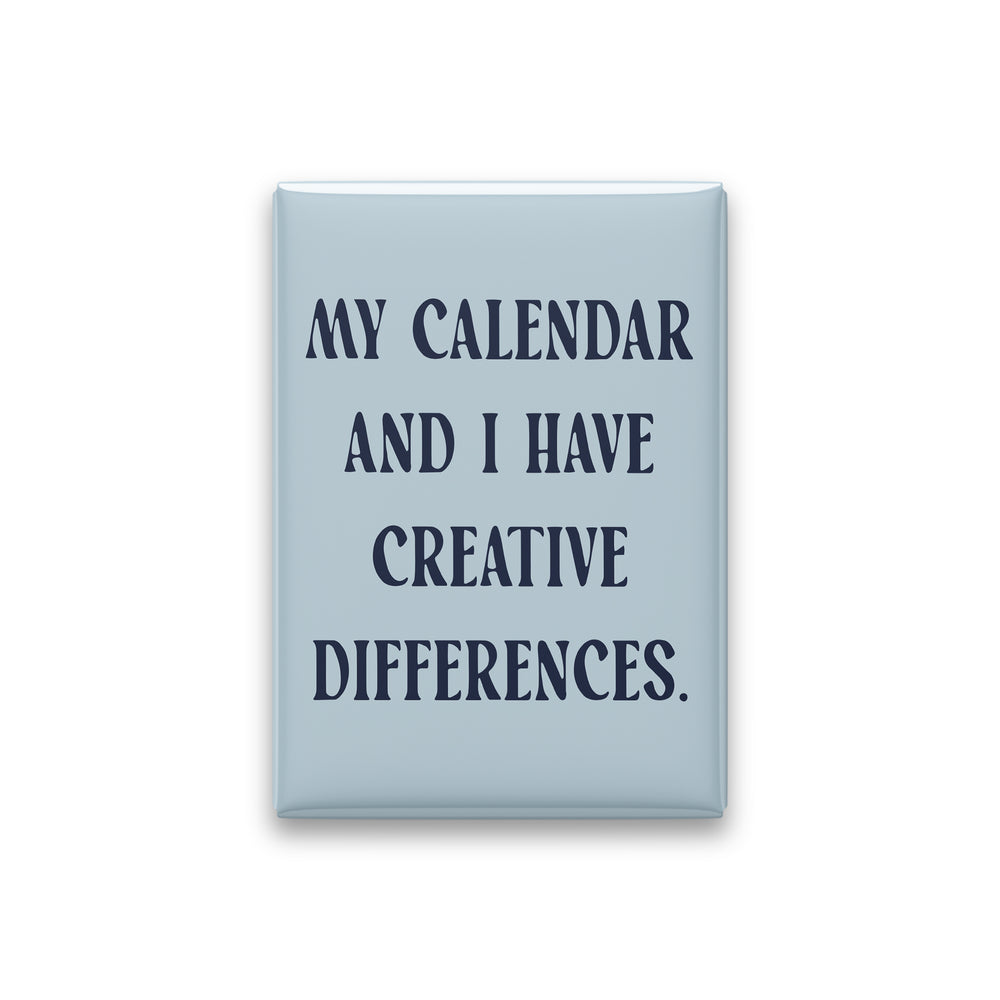 “My calendar and I have creative differences.” powder quote magnet on white