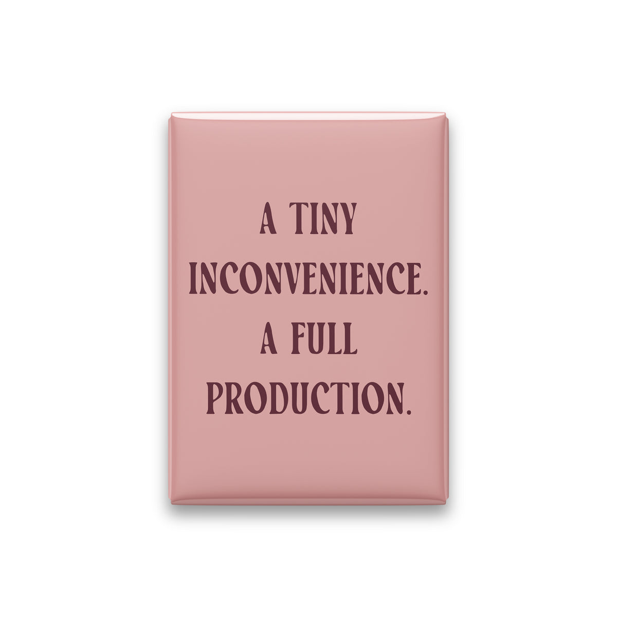 “A tiny inconvenience. A full production.” blush quote magnet on white