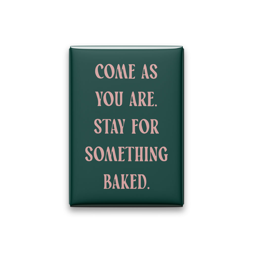 Come as you are. Stay for something baked. Small Talk magnet with Blush lettering on a Spruce background, on white