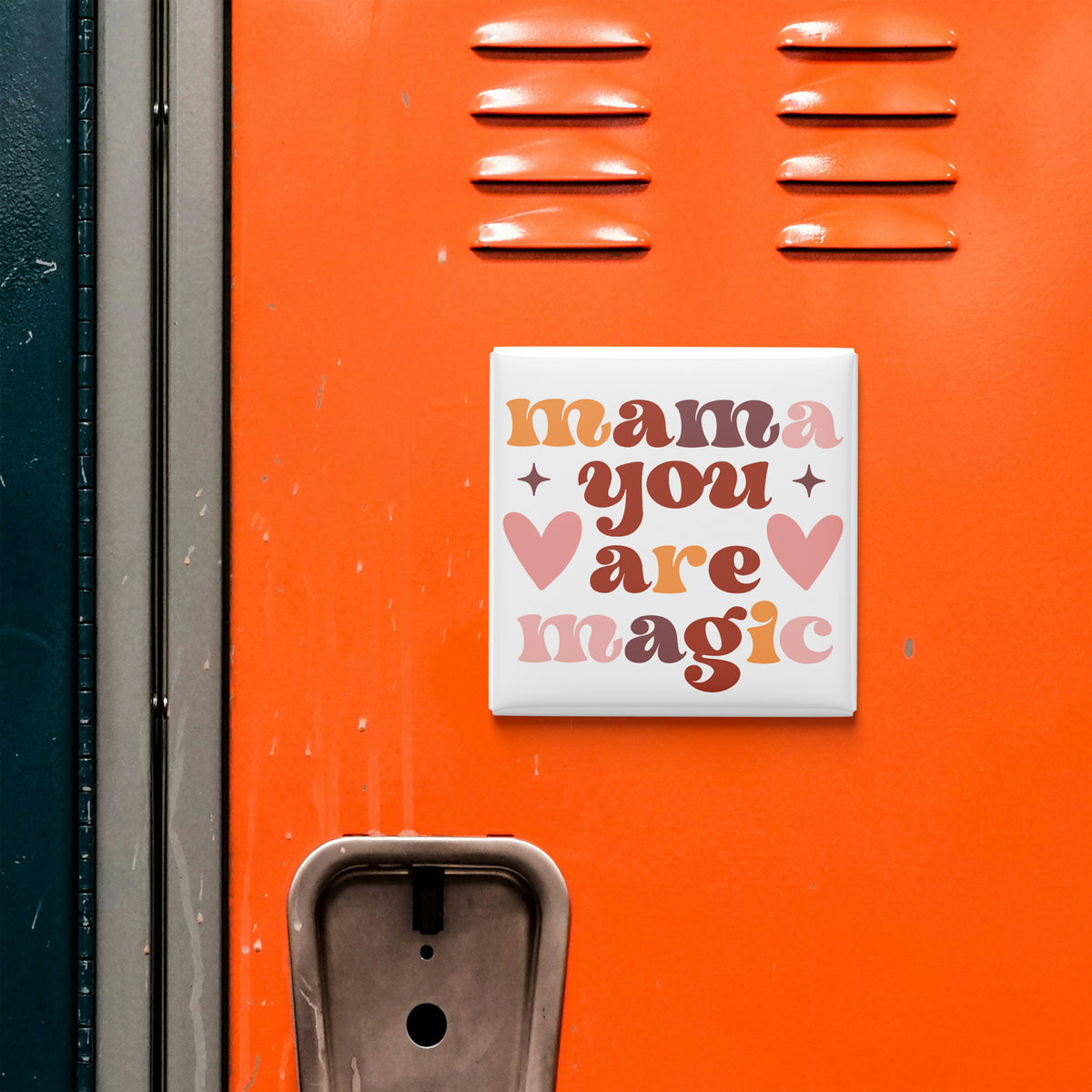 a vibrant orange wall with a white sign that reads "mama you are magic" in a playful font.