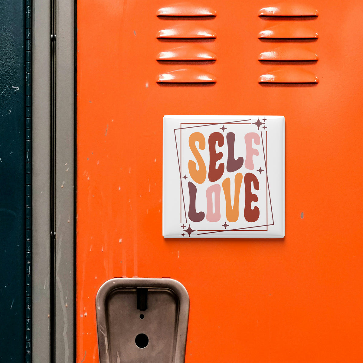 a vibrant orange wall with a white square sticker that reads "SELF LOVE" in bold, colorful letters.