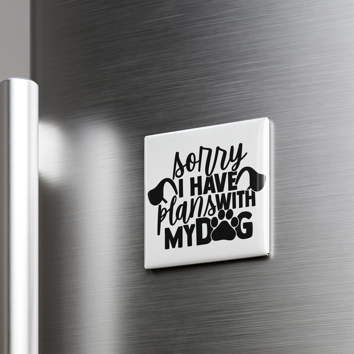 A white refrigerator magnet with the text "Sorry I have plans with my dog" printed on it.