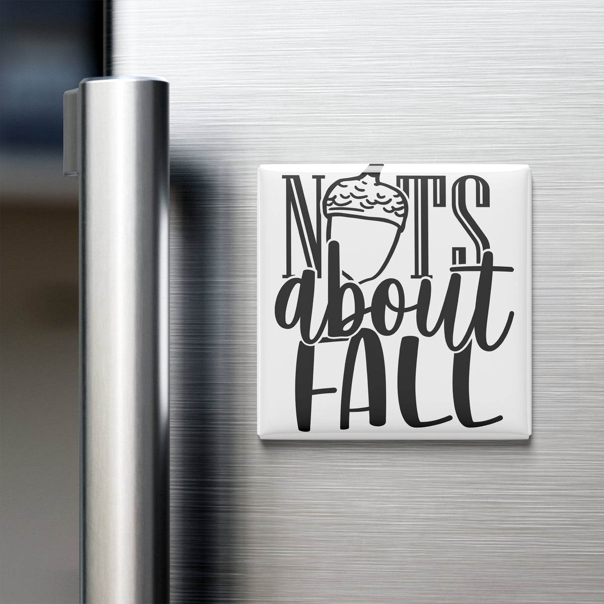 A white refrigerator magnet with the text "NOTS ABOUT FALL" printed on it.