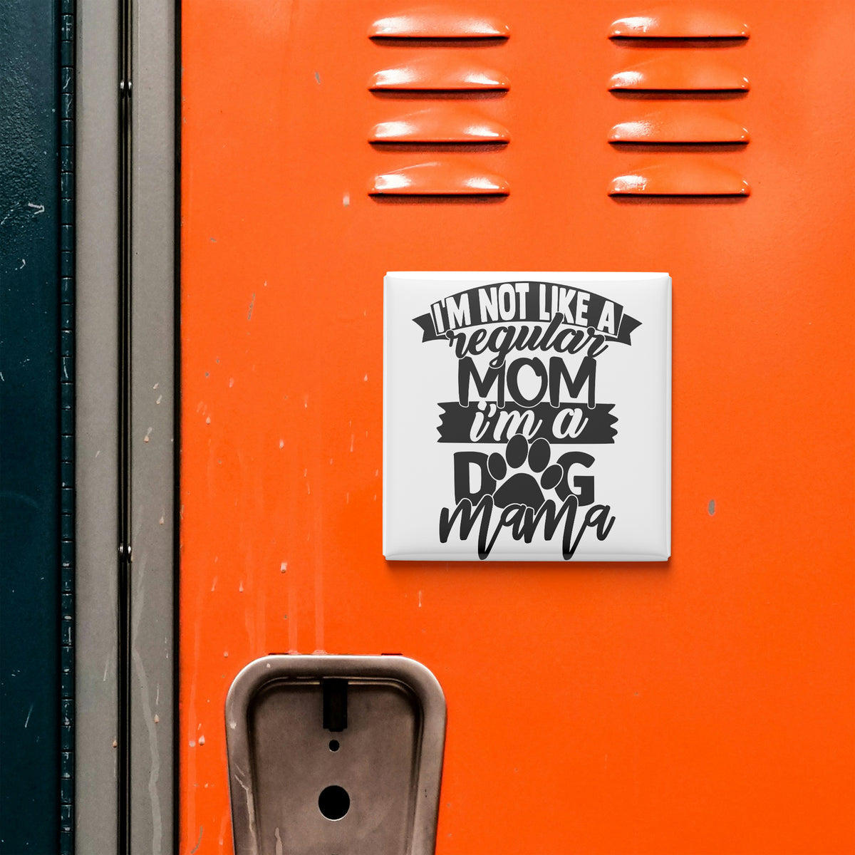 a sticker with the text "I'M NOT LIKE A REGULAR MOM I'M A DOG MAMA" on an orange surface, which appears to be a locker or a wall.
