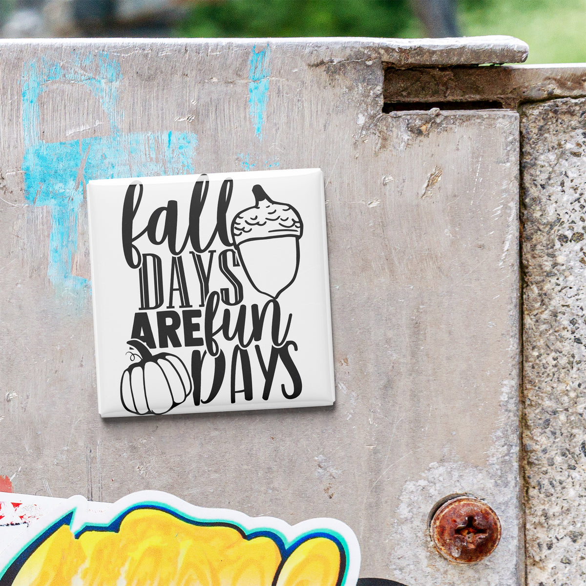 A sticker with the text "fall days are fun days" is attached to a concrete surface.