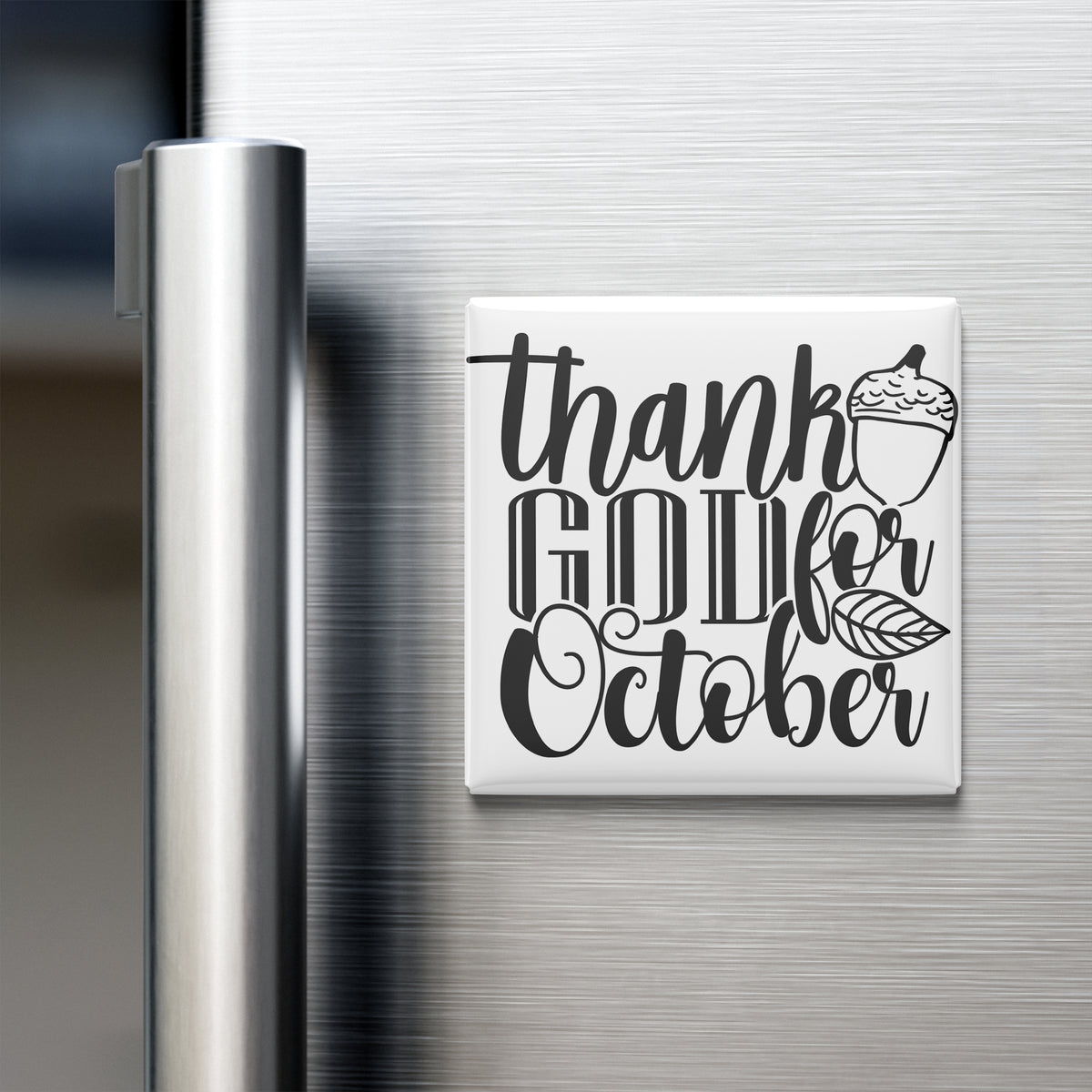 A refrigerator door with a white magnet that says "Thank GOD for October" in a stylized font.