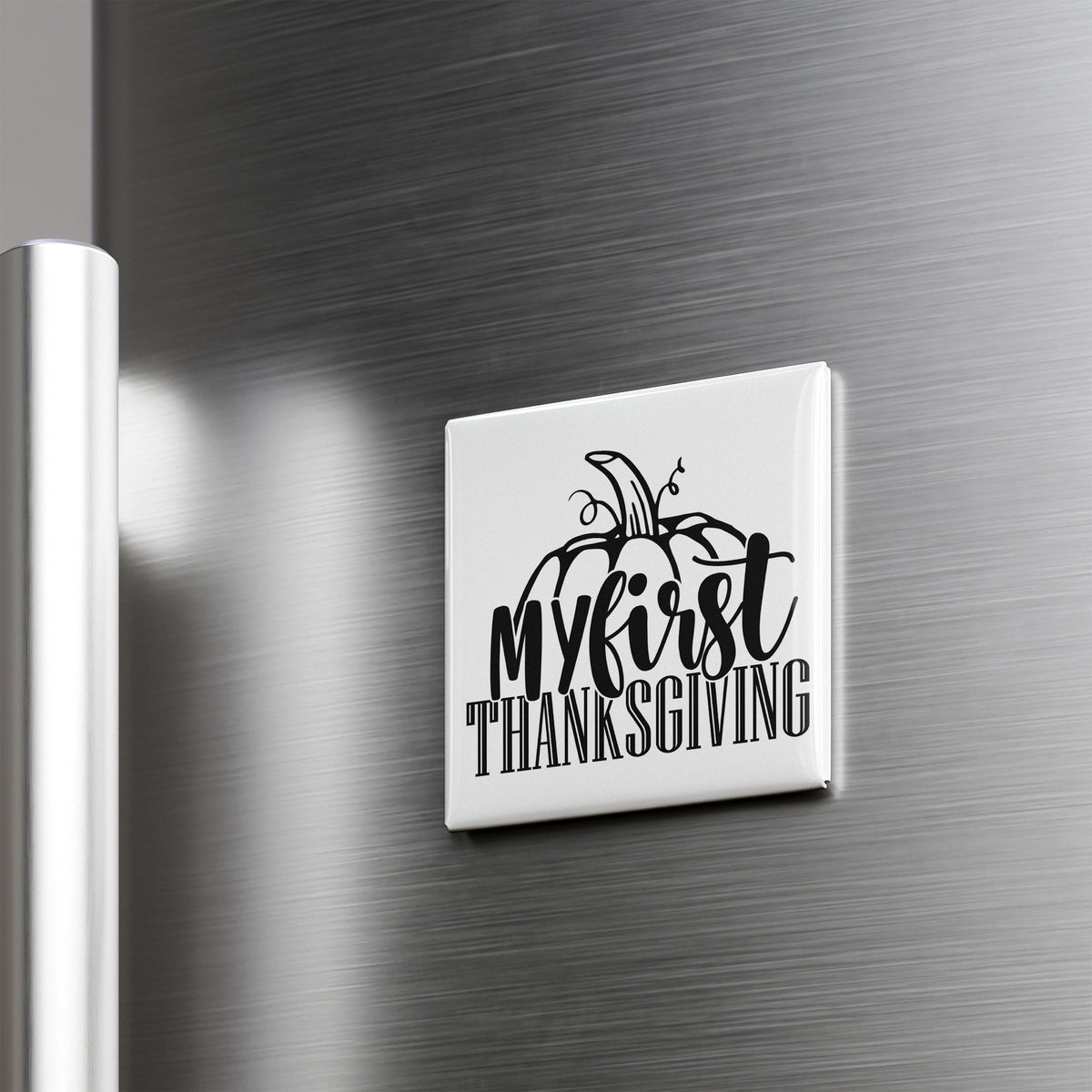 A white refrigerator magnet with the text "My first Thanksgiving" printed on it.