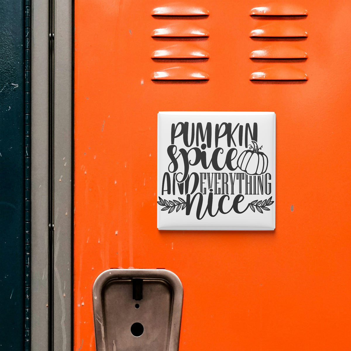 a vibrant orange wall with a white sign that reads "Pumpkin spice and everything nice" in a playful, decorative font.