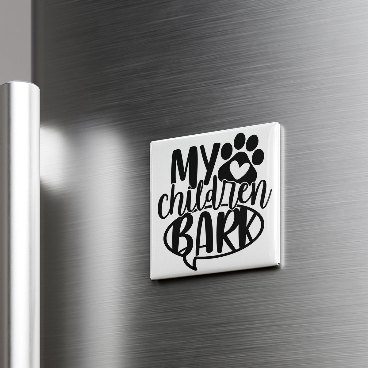 A refrigerator door with a sticker or decal that says "My children bark" in a stylized font.