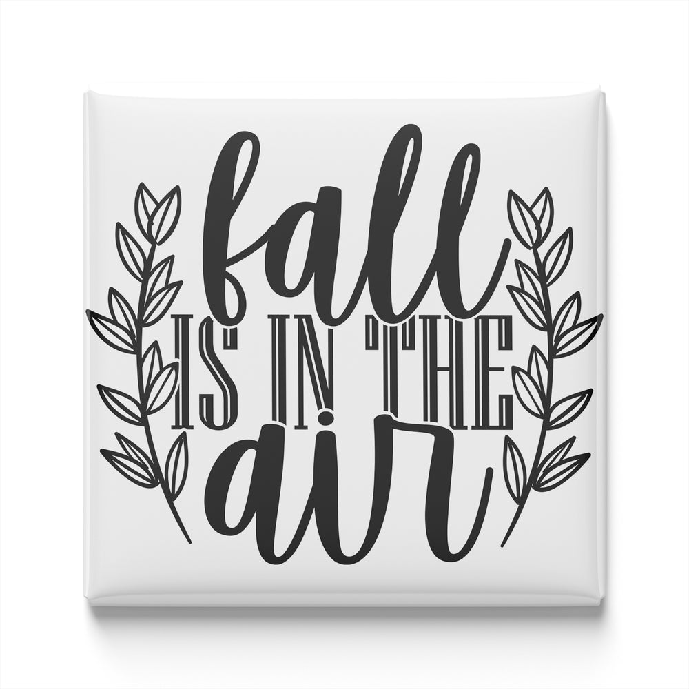 the text "fall is in the air" in a stylized font, surrounded by decorative leaves.