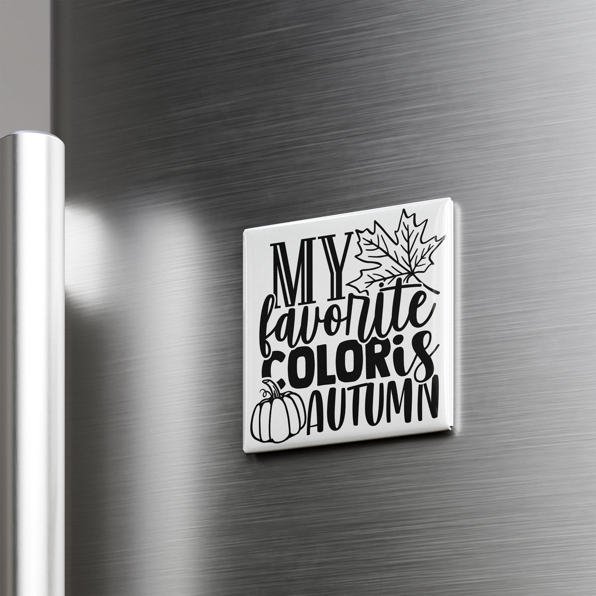 A white square magnet with black text and graphics on a metallic surface.