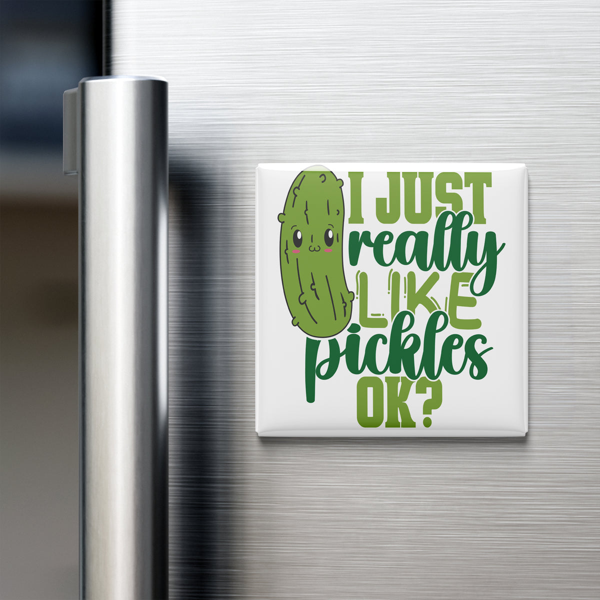 A humorous magnet on a refrigerator door that reads "I JUST REALLY LIKE PICKLES OK?" with a cartoon pickle face.