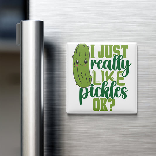 A humorous magnet on a refrigerator door that reads "I JUST REALLY LIKE PICKLES OK?" with a cartoon pickle face.